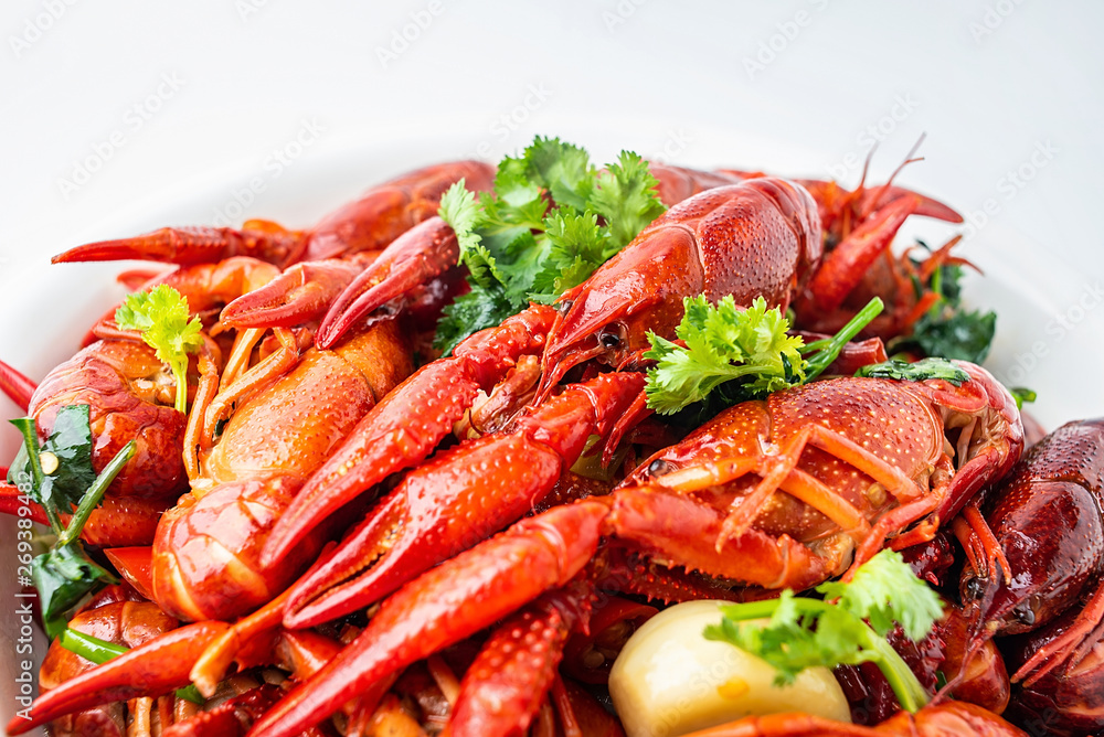A large bowl of bright red delicious braised crayfish on a white background A large bowl of bright red delicious braised crayfish on a white background
