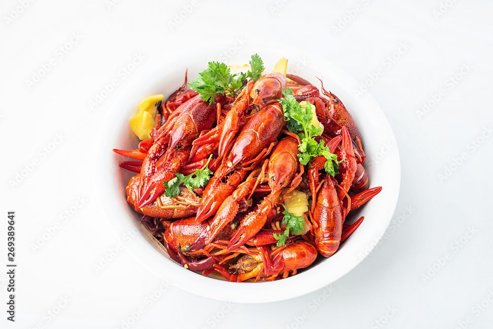 A large bowl of bright red delicious braised crayfish on a white background A large bowl of bright red delicious braised crayfish on a white background
