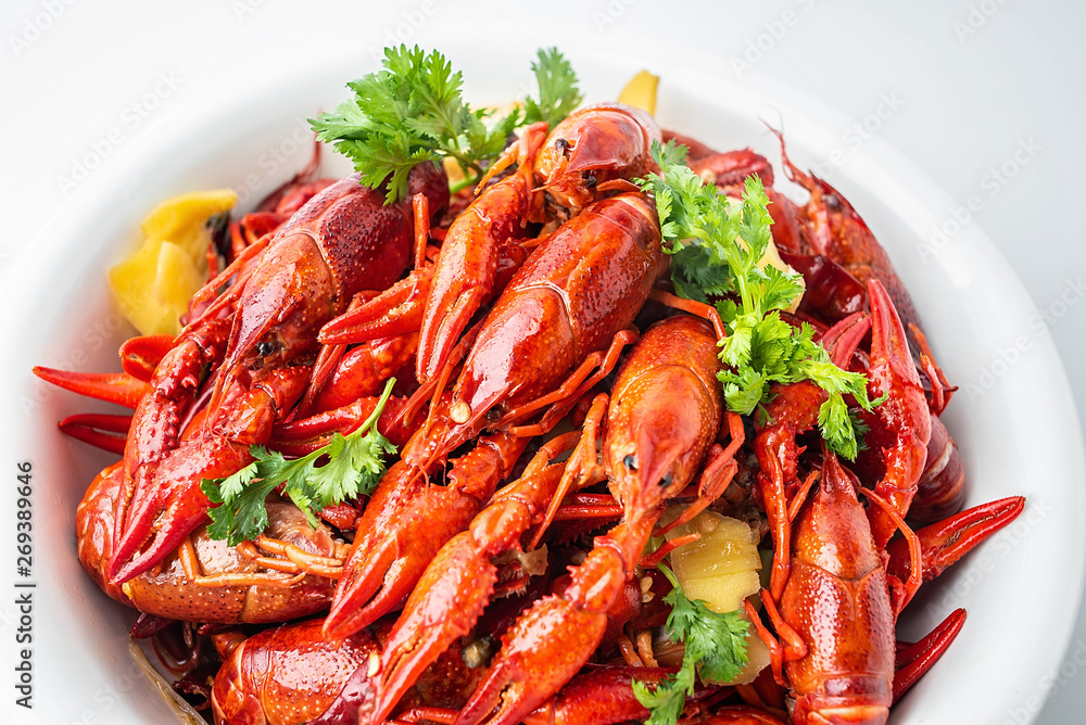 A large bowl of bright red delicious braised crayfish on a white background A large bowl of bright red delicious braised crayfish on a white background