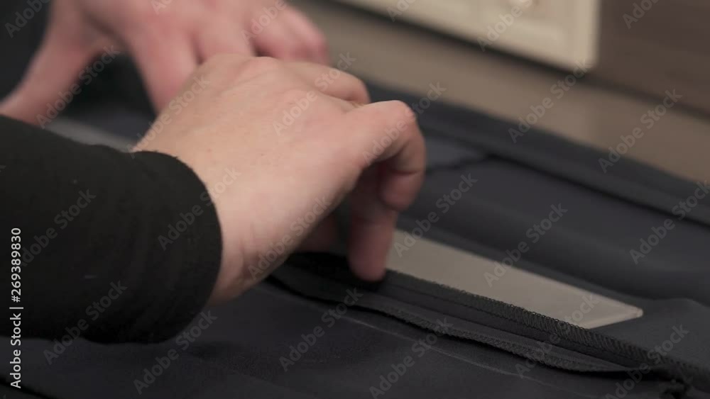A close-up video of a professional tailors hands measuring the material and preparing it for cutting. A close-up video of a professional tailors hands measuring the material and preparing it for cutting.