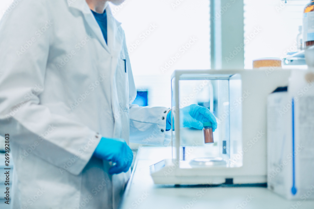 Scientist conducting an experiment in a lab Scientist conducting an experiment in a lab