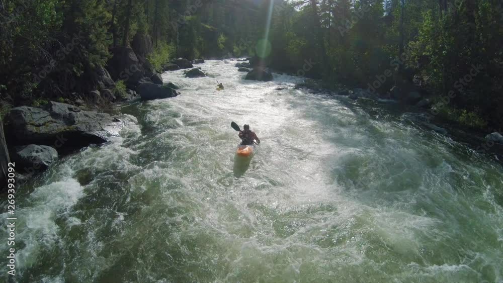 Man Kayaking Whitewater River Rapids Under Drone Flying Low Man Kayaking Whitewater River Rapids Under Drone Flying Low