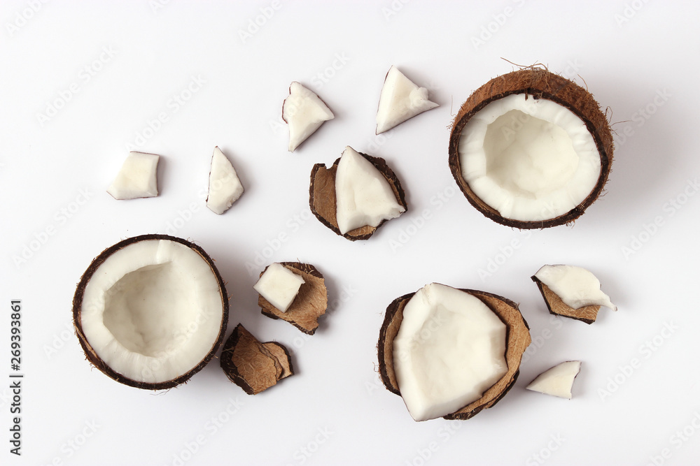 broken coconut on a white background top view. broken coconut on a white background top view.