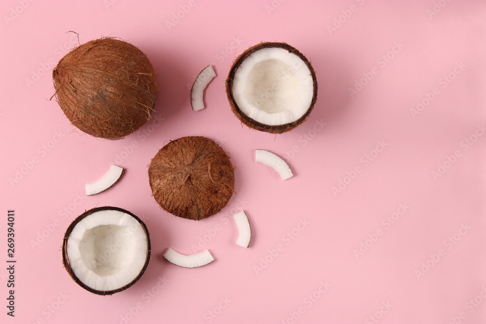 broken coconut on a colored background top view. broken coconut on a colored background top view.