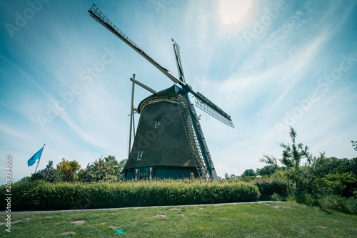 old Dutch windmill, Amsterdam De Riekermolen, Amstelpark, Amstel River photo