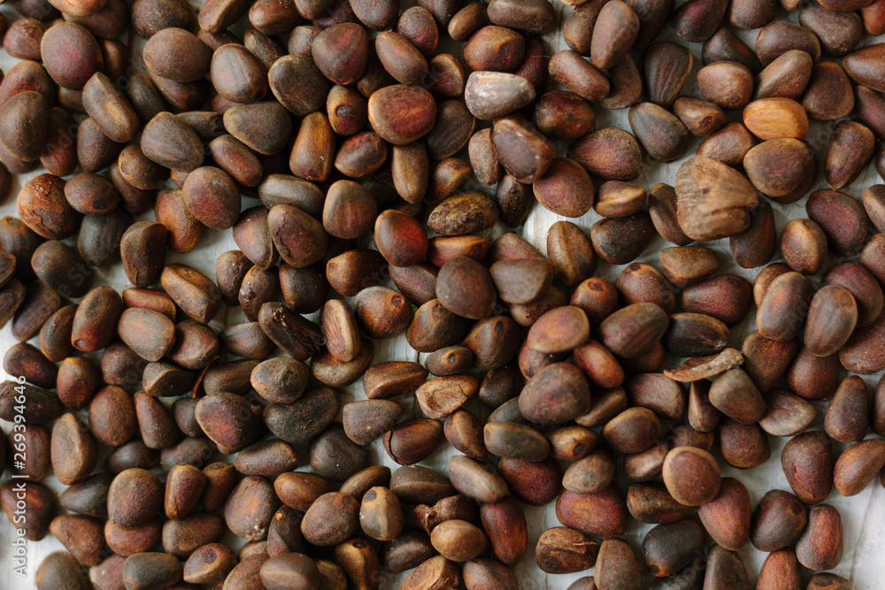 Heap of fresh and ripe pine nuts over white wooden table. Heap of fresh and ripe pine nuts over white wooden table.