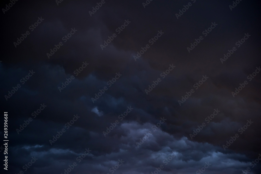 Weather in summer with black cloud and storm, Dark sky and dramatic storm clouds at night Weather in summer with black cloud and storm, Dark sky and dramatic storm clouds at night
