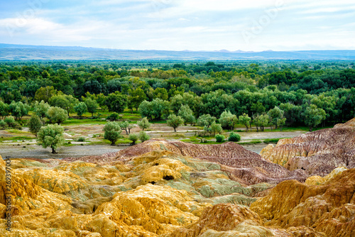 Rainbow Beach, Five Colored Hills scenic area, an oasis in the desert near Burqin. Buerjin, Altay, Xinjiang Province, China. Colorful hills and the beautiful Irtysh River. Exotic Asia Landscapes photo