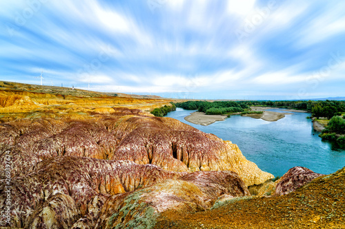 Rainbow Beach, Five Colored Hills scenic area, an oasis in the desert near Burqin. Buerjin, Altay, Xinjiang Province, China. Colorful hills and the beautiful Irtysh River. Exotic Asia Landscapes