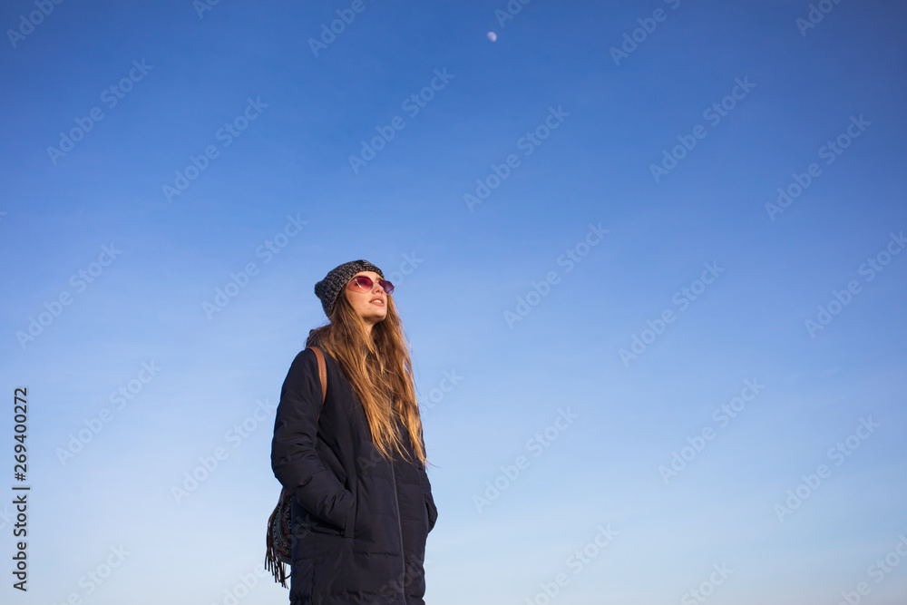 portrait of young woman in winter cloth in front of blue sky portrait of young woman in winter cloth in front of blue sky