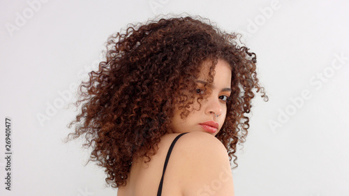 Slika na platnu hair blowing closeup portrait of mixed race model with freckles backside shood a
