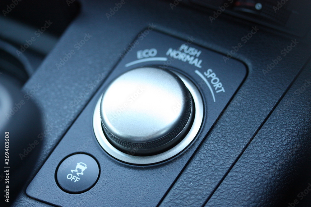 Traction control button and drive mode knob