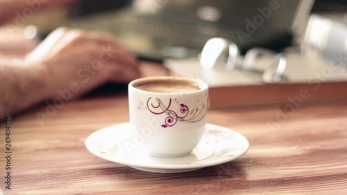 Man working with laptop and drinking coffee