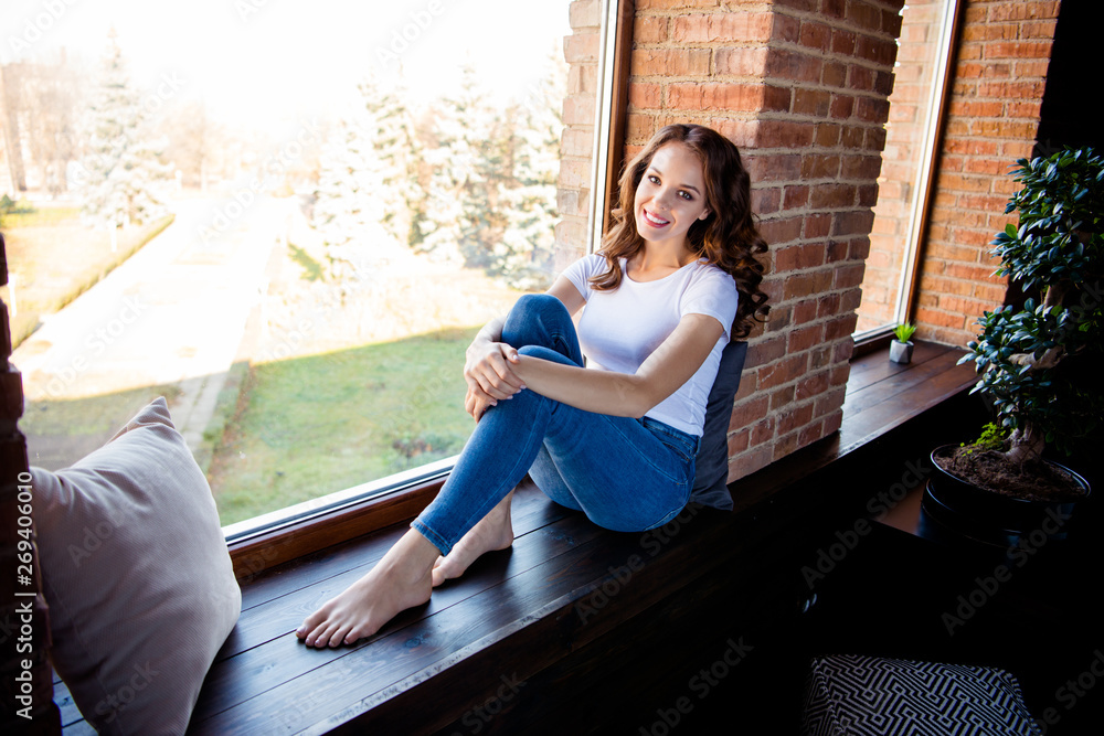 Portrait of her she nice-looking attractive lovely charming fit slim thin cheerful cheery wavy-haired girl sitting on window sill at industrial loft wooden brick style interior indoors Portrait of her she nice-looking attractive lovely charming fit slim thin cheerful cheery wavy-haired girl sitting on window sill at industrial loft wooden brick style interior indoors