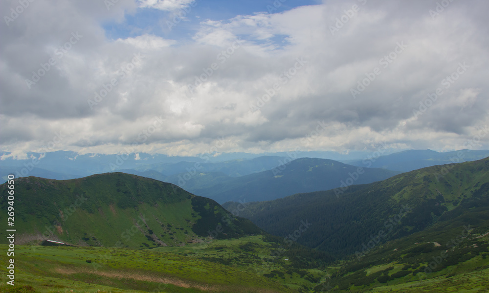 Naklejka premium Hiking with a tent through Petros to Hoverla, Lake Nesamovite, Mount Pop Ivan Observatory.