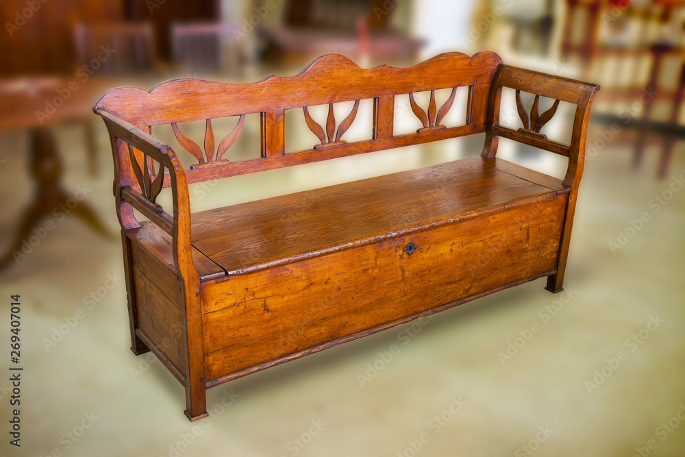 Old italian wooden renovated openable settle in a junk dealer shop Old italian wooden renovated openable settle in a junk dealer shop