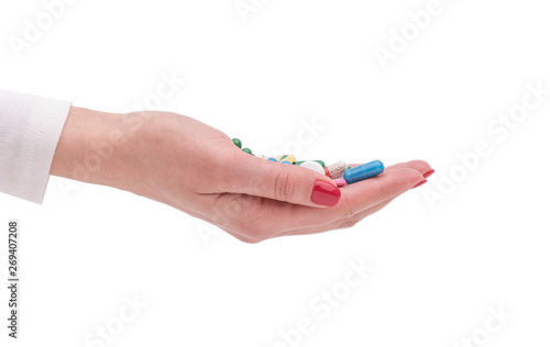 Beautiful female hand holds pill gesture.