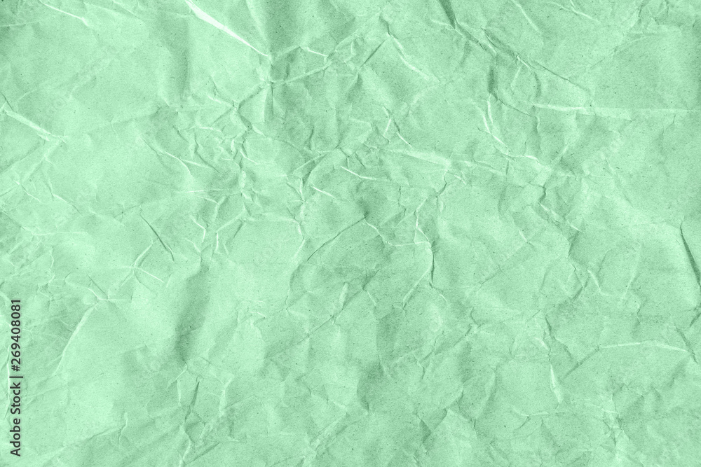 Obraz premium Trendy neo mint colored textured background. Crumpled craft paper. Flat lay. Color of the year 2020