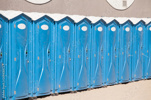 Row of blue portable, mobile toilets photo