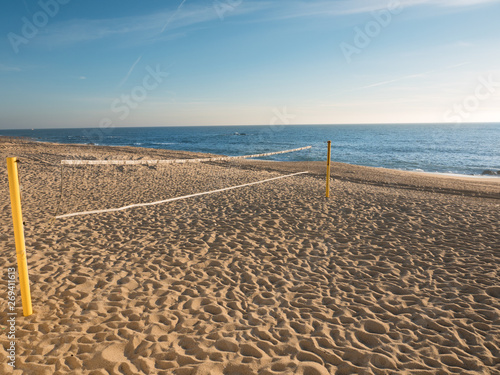 Beach volleyball net on an empty sandy beach in summer