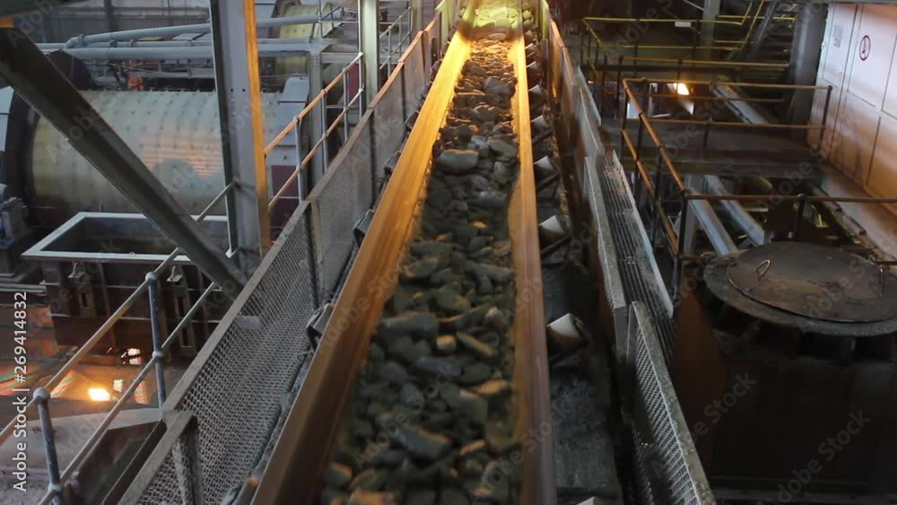 Stones are moving along the conveyor belt in a factory. Mining factory. Stones are moving along the conveyor belt in a factory. Mining factory.