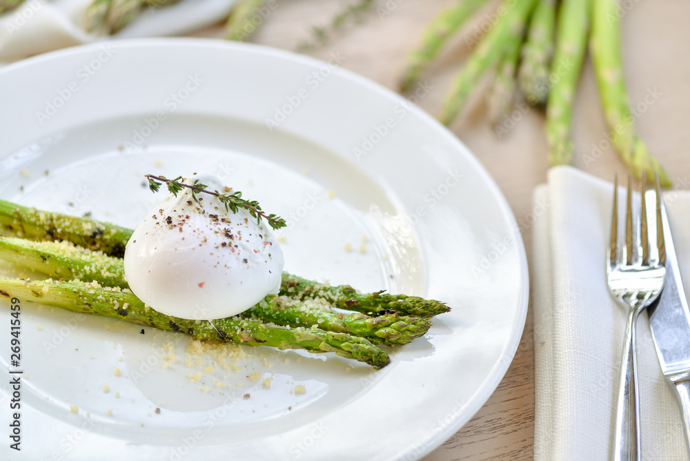 poached egg with asparagus on a white plate poached egg with asparagus on a white plate