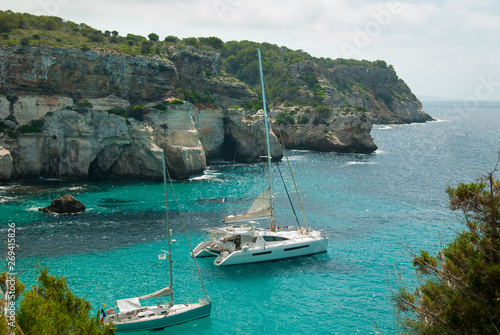 Two sailboats moored in a small bay of Minorca island