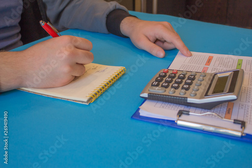 Businessman hand using calculator, accounting concept. Man hands with pencil, notebook and Calculator