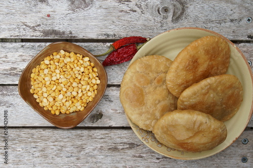 A deep fried poori or kachauri with sicy lenti filling. photo