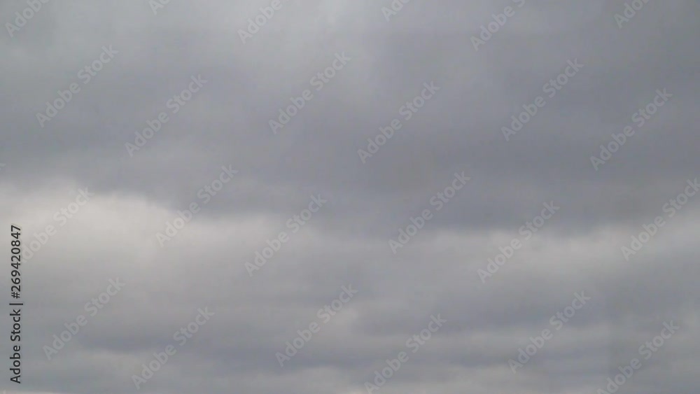 cloudy sky with trees passing by in foreground winter iowa cloudy sky with trees passing by in foreground winter iowa