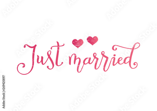 Modern calligraphy of Just married in pink decorated with two pink hearts and texture on white background