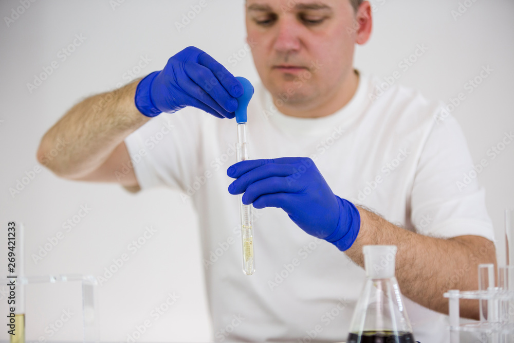 Scientist working with pharmaceutical cbd oil in a laboratory with glass equipment Scientist working with pharmaceutical cbd oil in a laboratory with glass equipment