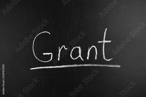 Writing the word Grant on a blackboard
