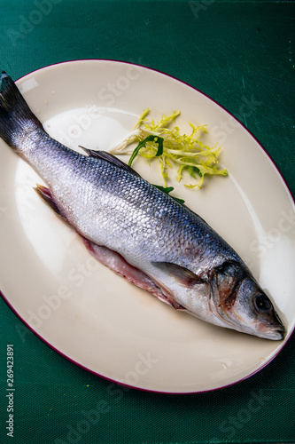fresh sea bass on a white plate
