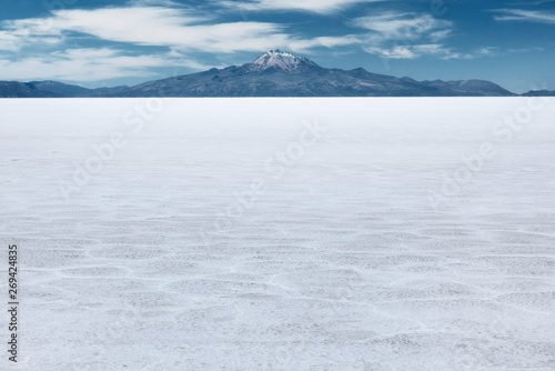 The world's largest salt flat and dormant volcano Tunupa at the far background, Salar de Uyuni, Bolivia  photo