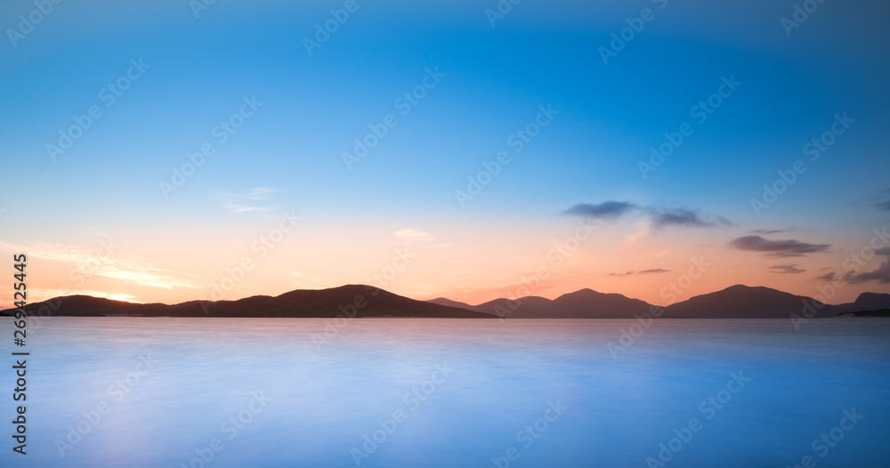 Isle of Harris landscape - sunset sky over mountains, beautiful endless sandy beach and turquoise ocean Isle of Harris landscape - sunset sky over mountains, beautiful endless sandy beach and turquoise ocean