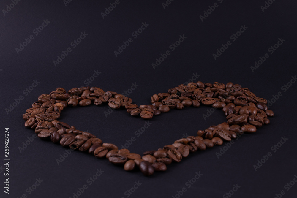 Big heart of coffee beans on a dark surface Big heart of coffee beans on a dark surface