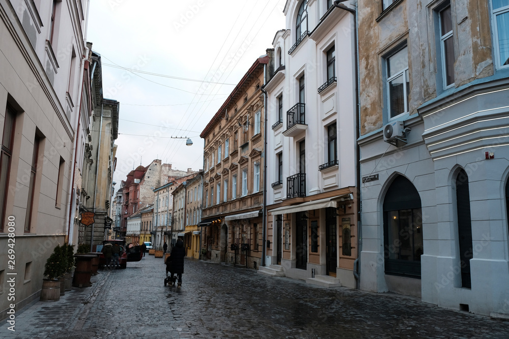 City center, people walk, the old stone road. Street in the city of Lviv Ukraine 03.15.19