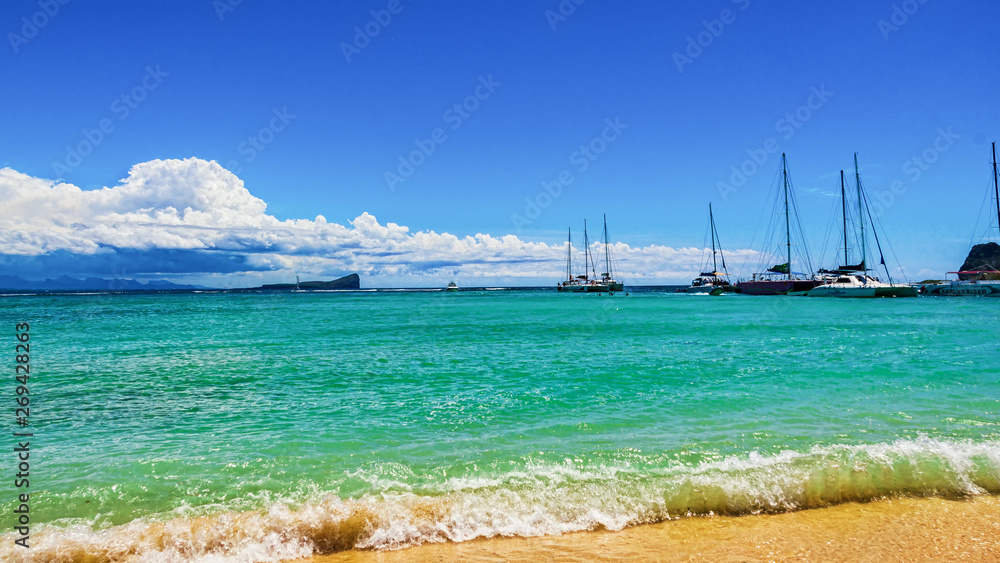 view of the sea coast, beach with yellow sand, blue sky with clouds, yachts on the water view of the sea coast, beach with yellow sand, blue sky with clouds, yachts on the water