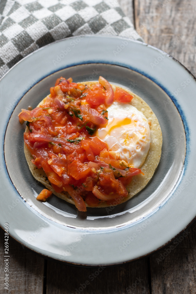 Mexican food: Fried egg rancheros with sauce and corn tortilla Mexican food: Fried egg rancheros with sauce and corn tortilla