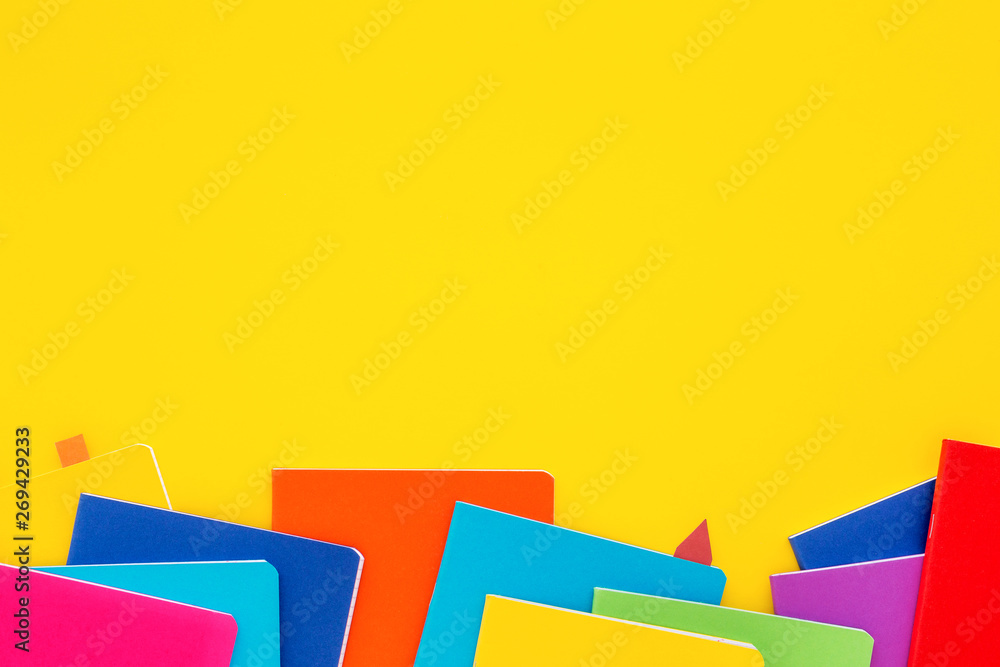 Stack of notebooks on yellow background. Copy space. Stack of notebooks on yellow background. Copy space.