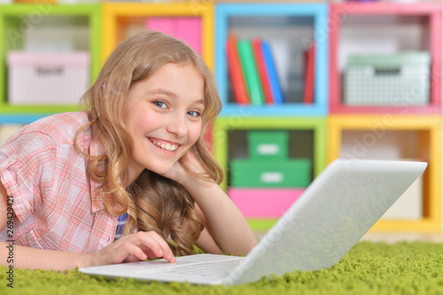 Portrait of emotional cute girl using laptop