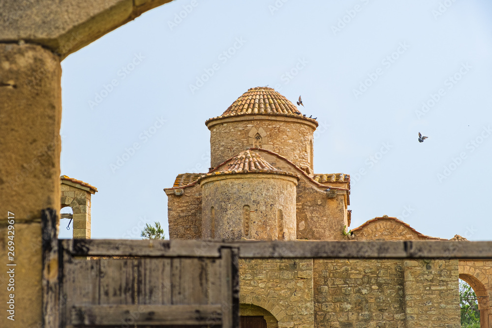 Panayia Kanakaria 6th century Byzantine Monastery Church in Lythrangomi, Cyprus with pigeons flying off its dome