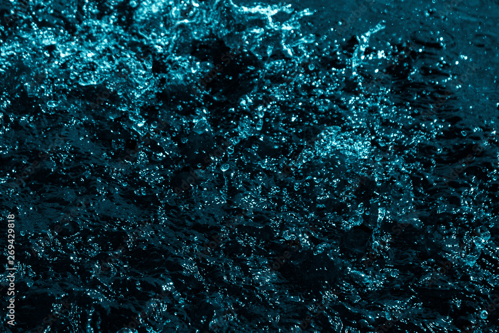 splashes and flying drops of water on a dark background, bokeh defocused splashes and flying drops of water on a dark background, bokeh defocused
