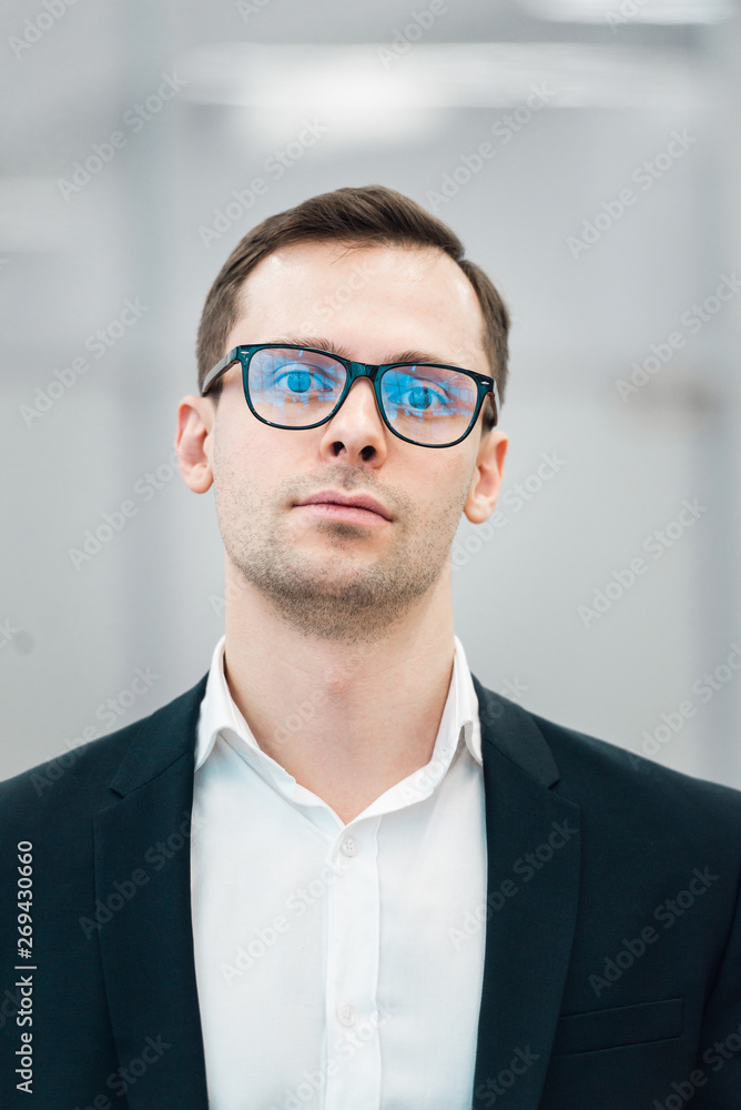 Young handsome man wearing fashion eyeglasses against neutral background with lots of copy space Young handsome man wearing fashion eyeglasses against neutral background with lots of copy space