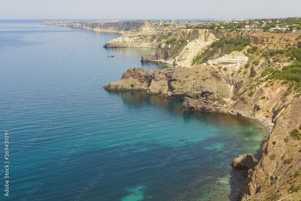 Obraz premium Rocky steep shore of the blue Black sea. The Western part of the Crimean Peninsula.