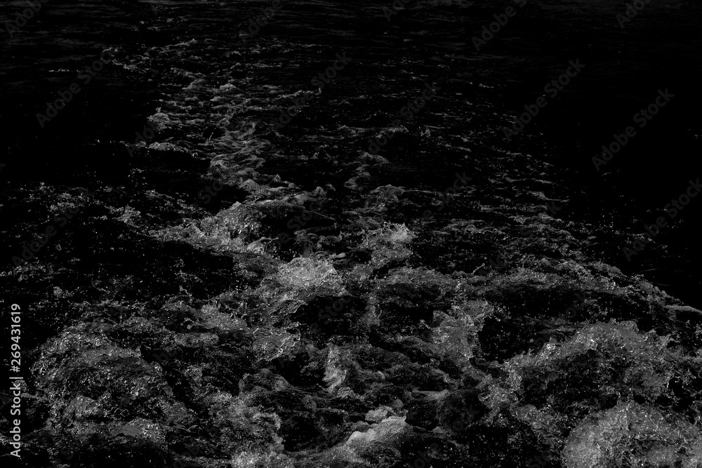 splashes and flying drops of water on a dark background, bokeh defocused splashes and flying drops of water on a dark background, bokeh defocused