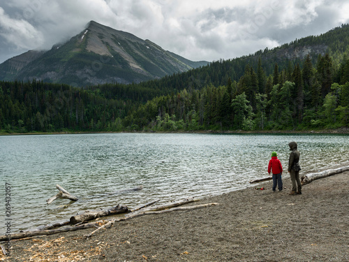 Tourists at lakeshore, Crandell Lake, Waterton Lakes National Park, Alberta, Canada