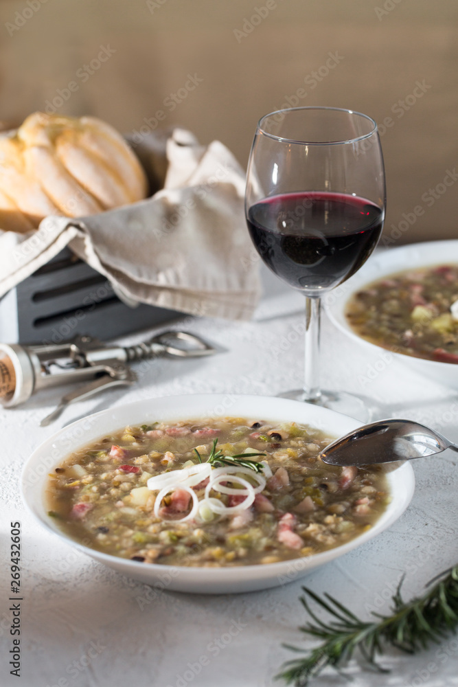 Rustic bean and farro soup with pancetta, onion, rosemary and celery. Italian food.