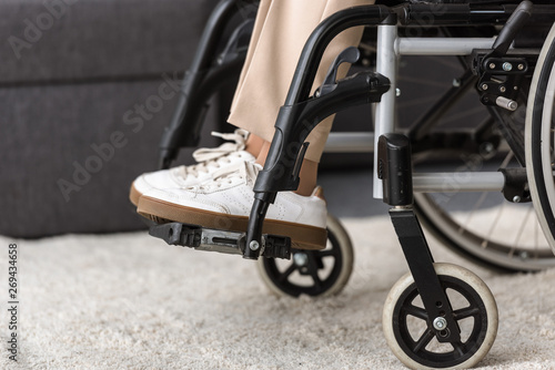 partial view of disabled senior woman on wheelchair